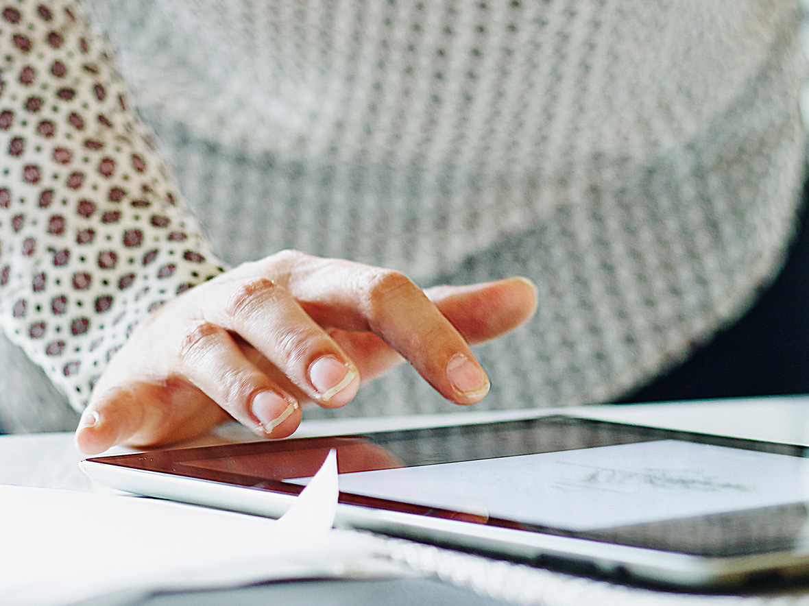 Image of a person clicking on an ipad screen