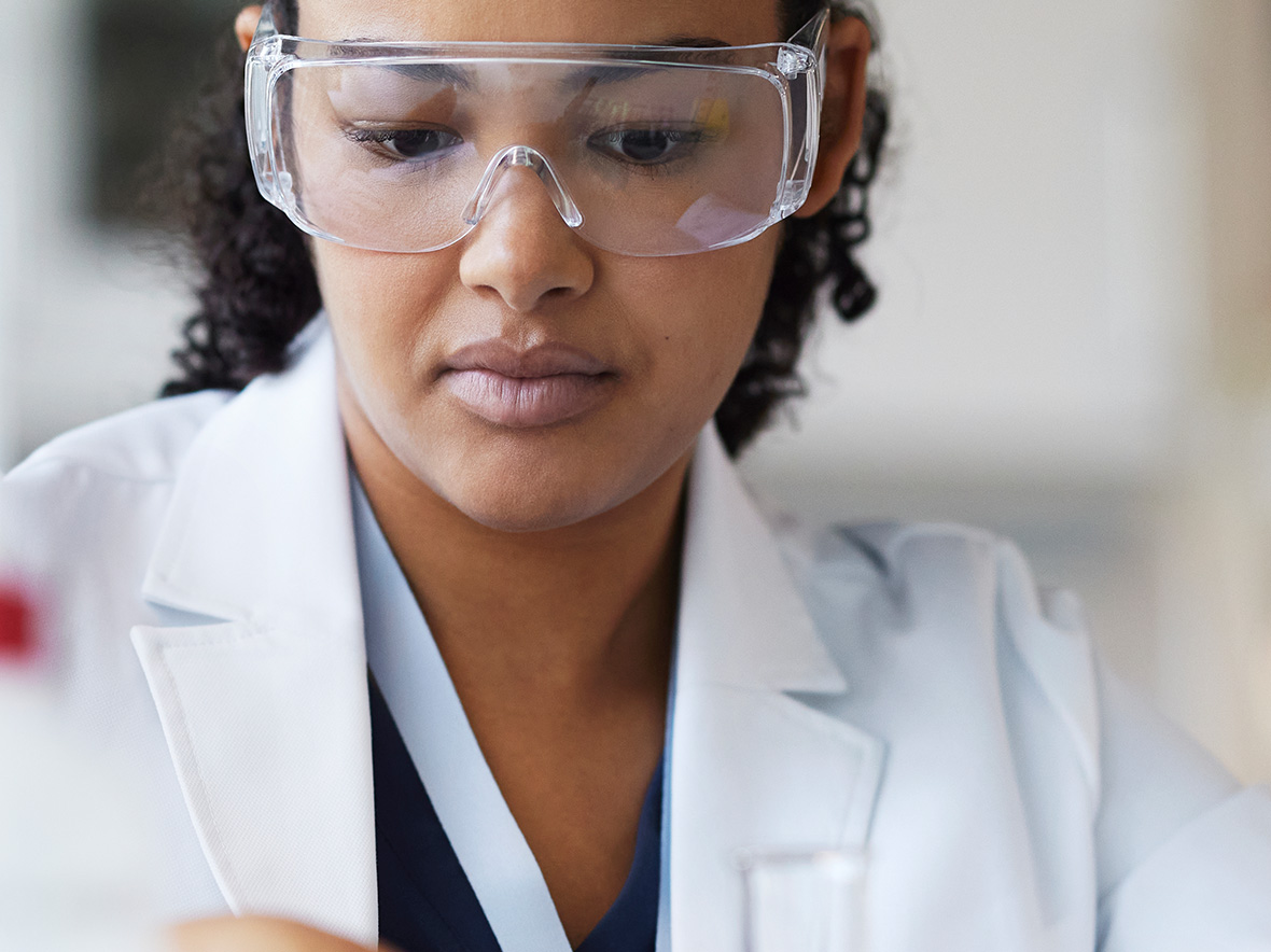 Clinician in the lab with safety goggles on