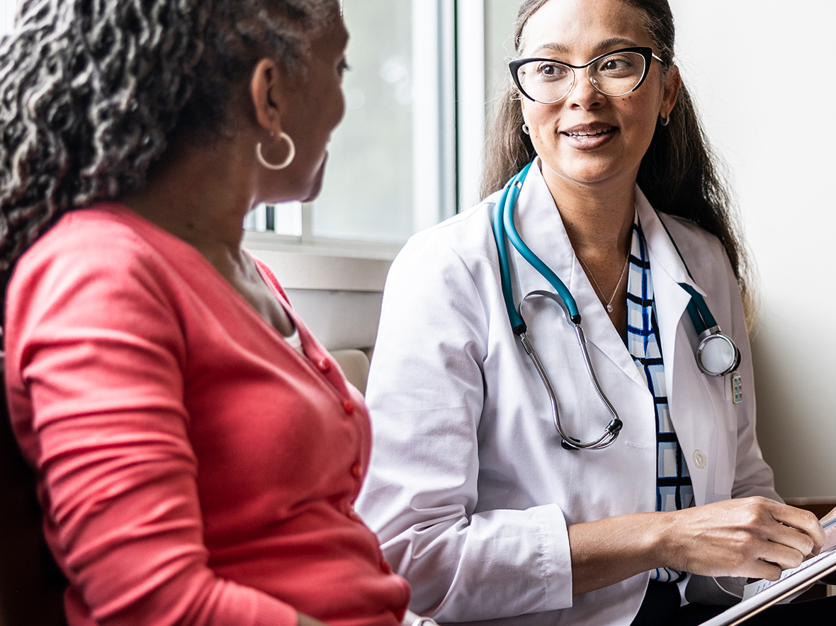 Doctor and patient sitting together and talking