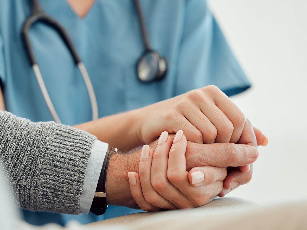 close up picture of doctor holding another person's hand