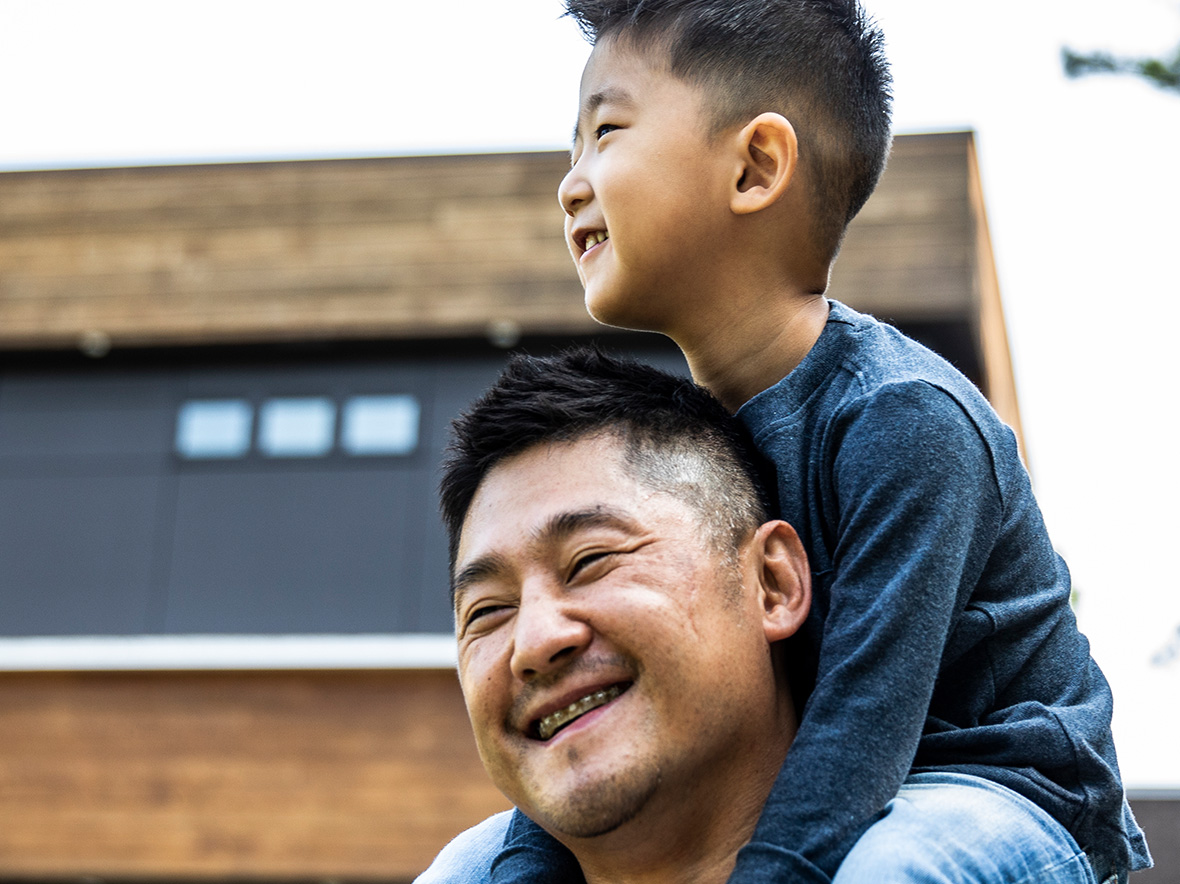 Image of son on father's shoulders